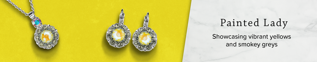 Rhodium plated pendant and earrings with gray and iridescent yellow crystals