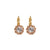 Gold plated earrings with clear gemstones on a white background